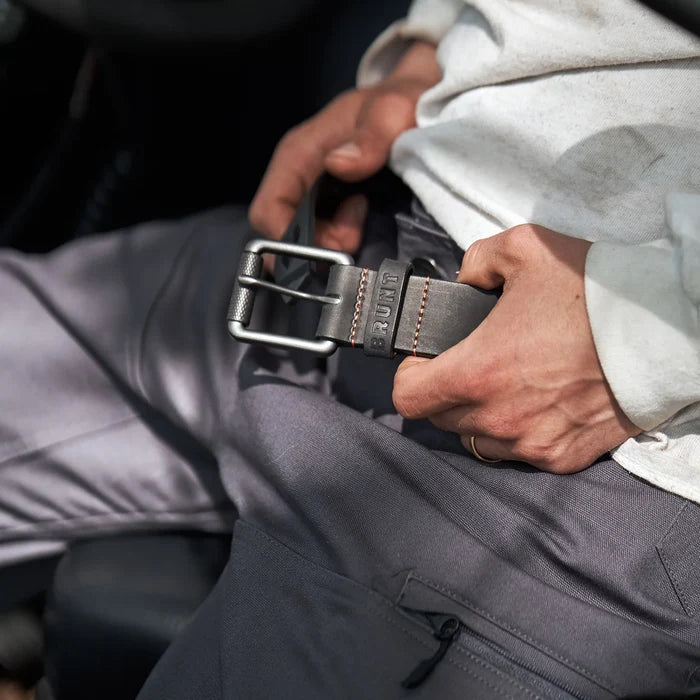 BRUNT black leather work belt shown worn, lifestyle photo of the belt on a tradesperson at work